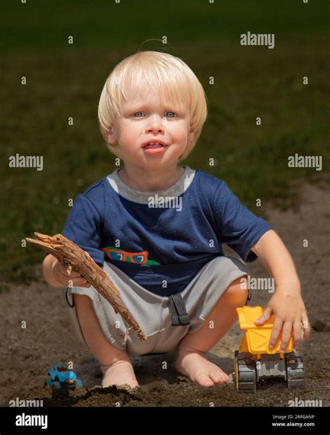 A young boy plays with a toy truck Stock Photo - Alamy