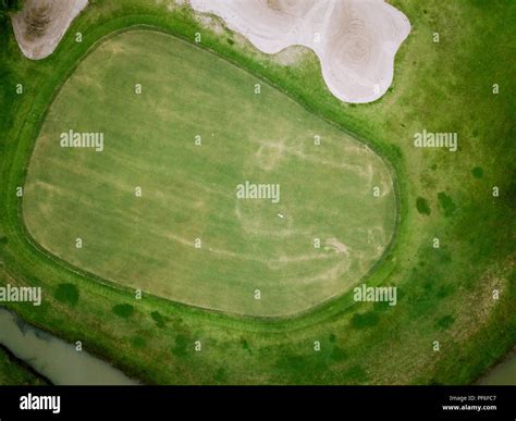 aerial view of golf hole with flag in golf course. aerial view by flying drone Stock Photo - Alamy