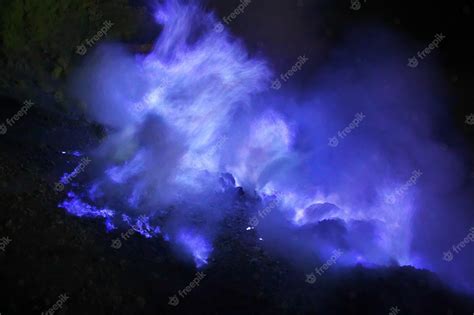 Premium Photo | The blue fire in fog at night on ijen volcano, indonesia