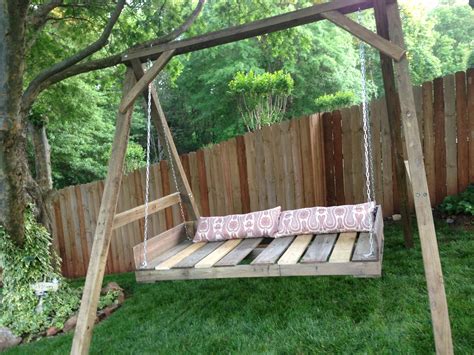 a wooden swing bed sitting in the middle of a yard