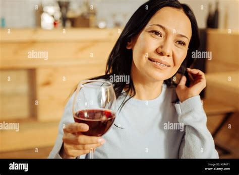 Exuberant woman drinking red wine Stock Photo - Alamy