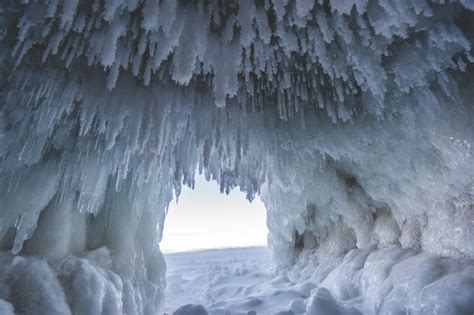 Explore stunning frozen ice caves and waterfalls during a Pictured Rocks winter weekend camping ...