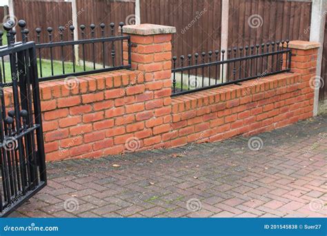 House Boundary Brick Wall with Wrought Iron Fence in between Stock Photo - Image of metal, wall ...