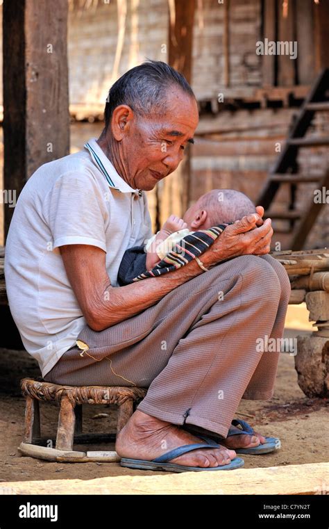 Khmu hill tribe, old man holding a baby, Luang Prabang, Laos Stock Photo - Alamy