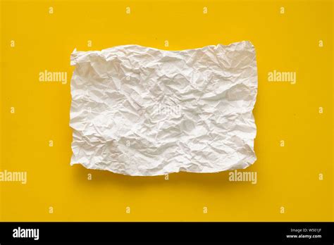 flat lay crumpled white paper sheet isolated on the table, background texture and copy space ...
