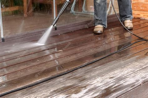 Premium Photo | Man cleaning walls and floor with high pressure