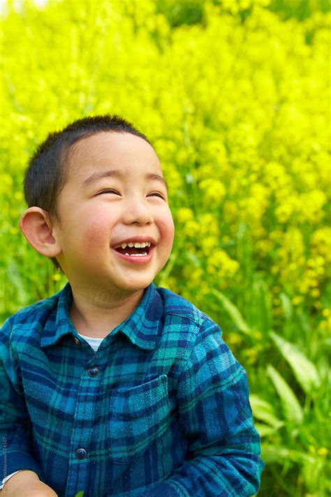 "Happy Little Chinese Kid Playing In Spring Field" by Stocksy ...