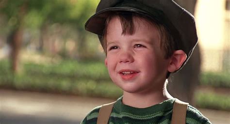 Download A Young Boy Wearing A Hat And A Striped Shirt | Wallpapers.com