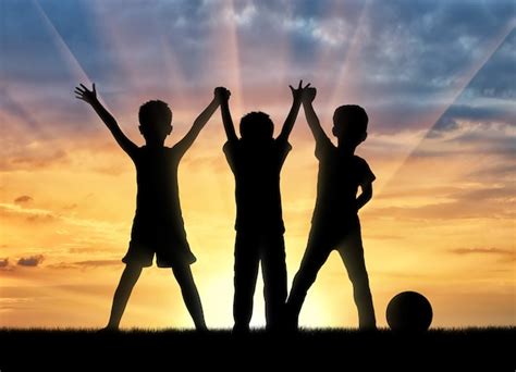 Premium Photo | Childhood concept. Three happy children holding hands at sunset