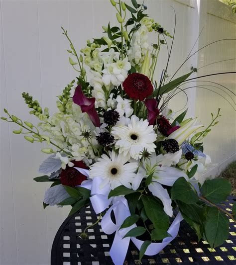 This black and white bouquet is dramatic and contemporary. The white flowers are orchids ...