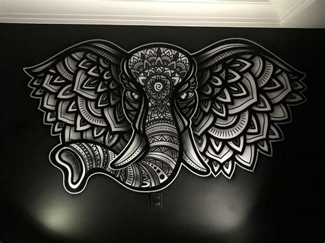 an elephant with intricate designs on it's face