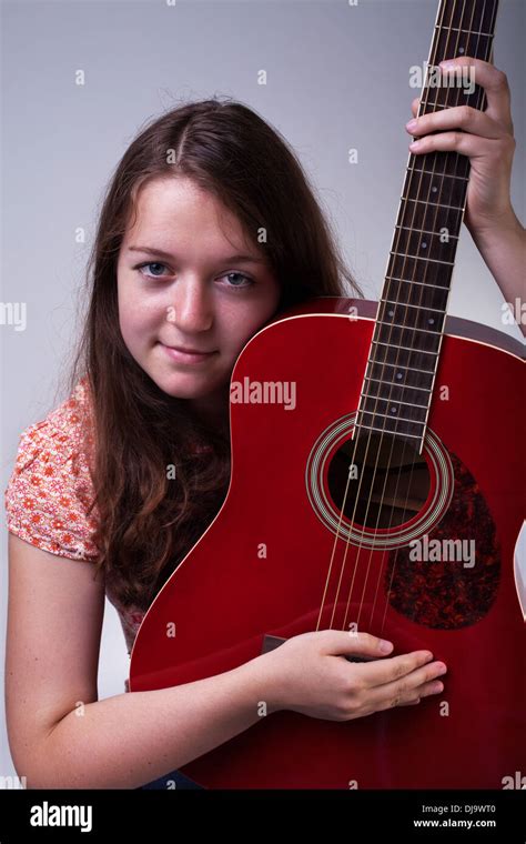 Young teenage girl with red guitar portrait Stock Photo - Alamy