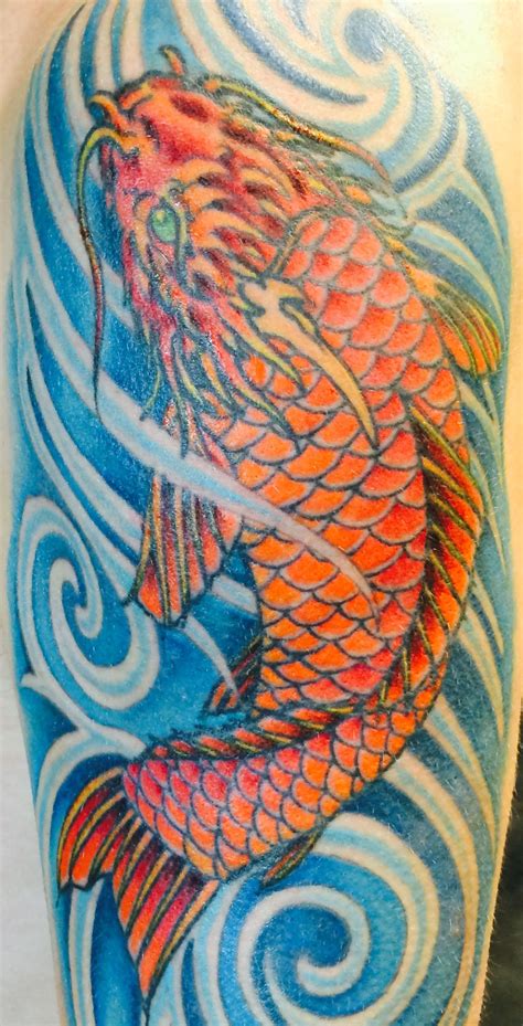 Dark orange Koi fish tattoo in deep blue swirling water. Symbolic of determination and ...