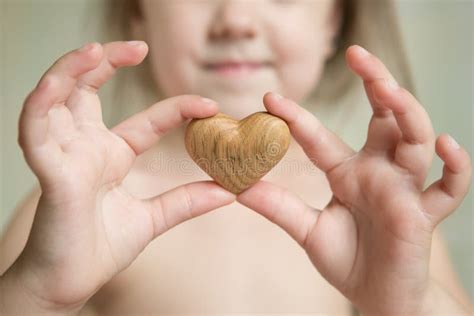 Tiny Baby Hands To Hold the Wooden Heart Stock Image - Image of fingers, feet: 102860049