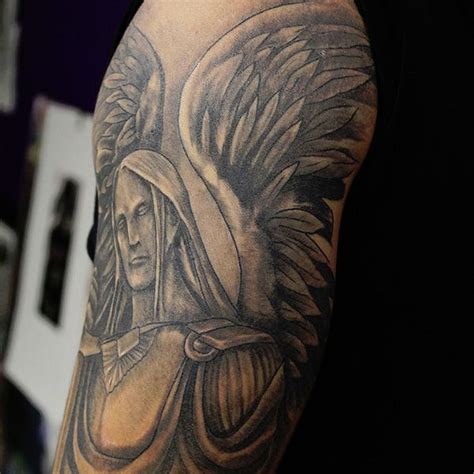 a man's arm with an angel tattoo on it