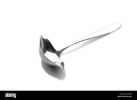 Stainless steel sauce spoon white isolated Stock Photo - Alamy