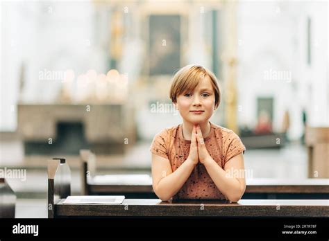 Little boy praying in church Stock Photo - Alamy