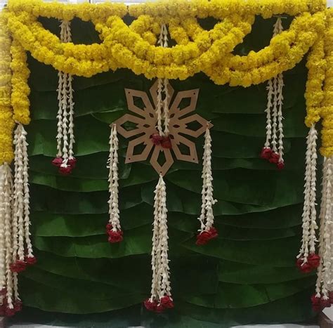 This cute backdrop for Puja is so simple nd elegant💛💚 #pujadecor #traditional #flowers # ...