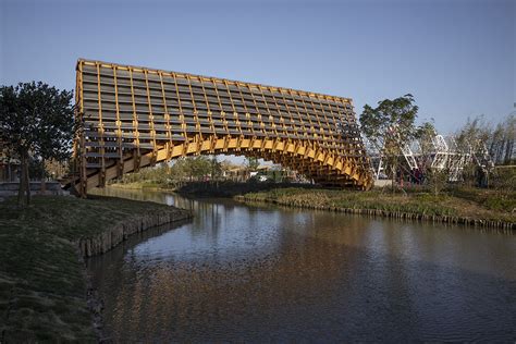 Arched timber bridge by LUO studio allows boats to pass under bridge ...