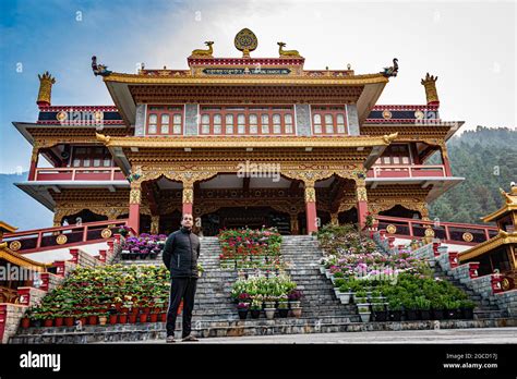 man standing near beautiful buddhist monastery at morning from flat angle image is taken at ...