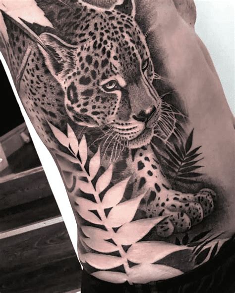 a man with a tattoo on his arm that has a leopard and leaves on it