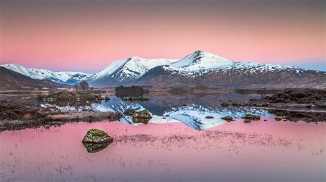 Premium Photo | A pink sky with snow capped mountains in the foreground and a pink sky with the ...