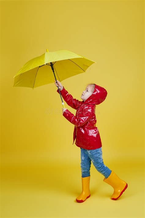 Cheerful Child Girl with Yellow Umbrella and Red Rain Coat on Colored Yellow Background. Stock ...