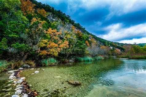 A Picturesque Scene with Fall Foliage on a Babbling Brook and Large Boulders at Lost Maples ...