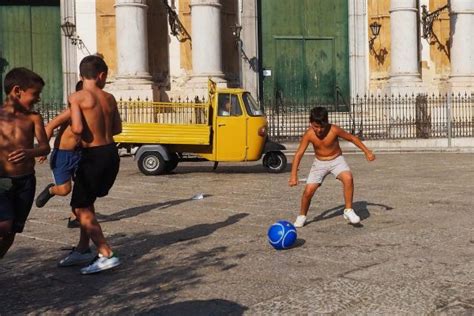 Children playing soccer on the street 2 - Exibart Street