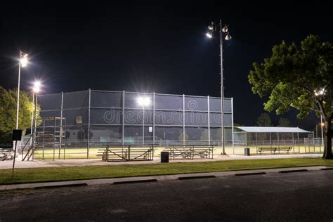 Empty Baseball Field With The Lights On At Night Stock Photo - Image ...