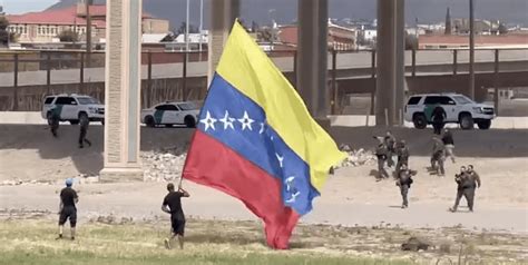 Illegal migrants attack CBP agents while waving huge Venezuelan flag ...