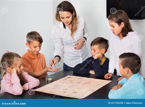 Boys and Little Girls Playing at Board Game Stock Photo - Image of ...