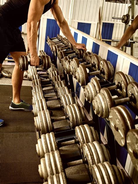 Man in Gym Workout with Fitness Equipment. Cropped Shot. Stock Photo ...