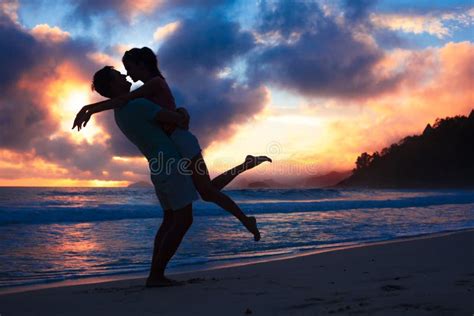 Sunset Silhouette of Young Couple in Love Hugging at Beach Stock Photo - Image of adult, nature ...