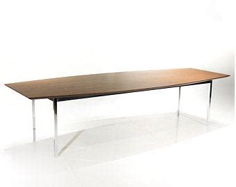 a wooden table sitting on top of a white floor