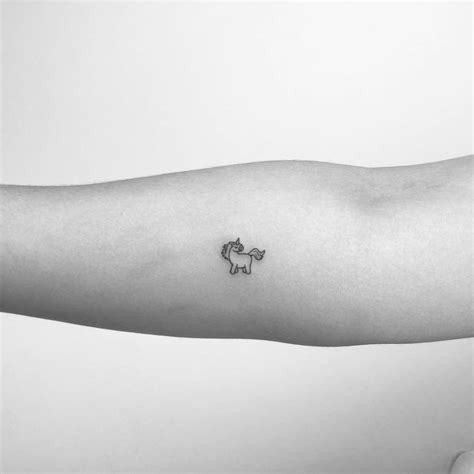 Tiny unicorn tattoo on the inner forearm.