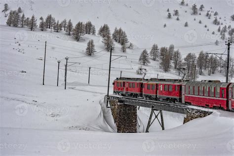 Red train in the snow in swiss alps 11968771 Stock Photo at Vecteezy