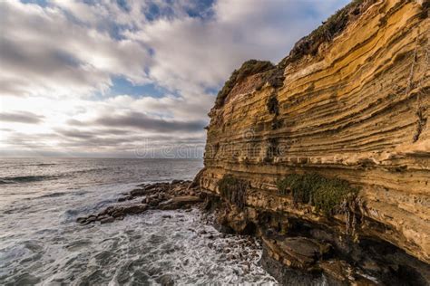 Rocky Cliff with Cloudy Sky and Ocean at Sunset Cliffs Stock Image ...