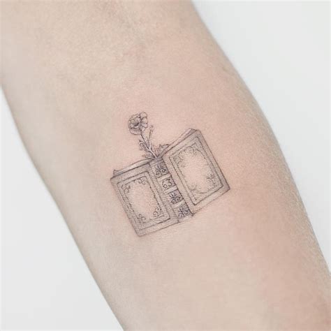 cute minimalist book tattoo by Marcela Badolatto - KickAss Things