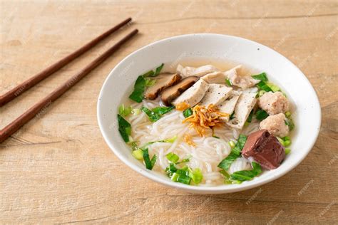 Premium Photo | Vietnamese rice noodles soup with vietnamese sausage served vegetables and ...