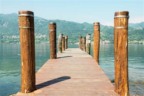 Wooden Dock And Posts On Lake Orta Photograph by Mats Silvan - Fine Art America