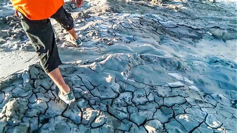 Walking on mud volcano during eruption