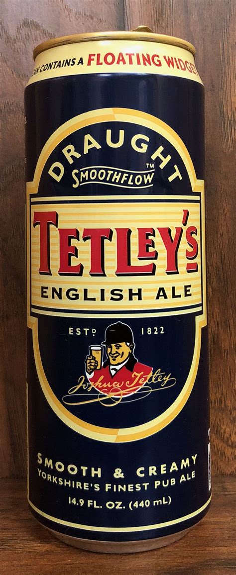 a can of tetley's english ale on a wooden table