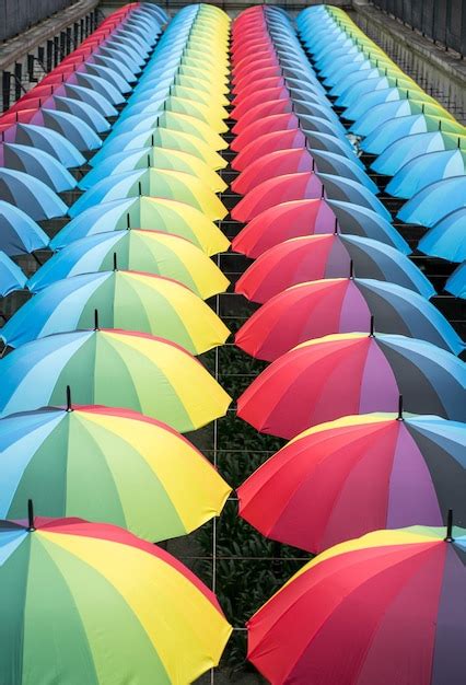 Premium Photo | Rows of rainbow color umbrellas