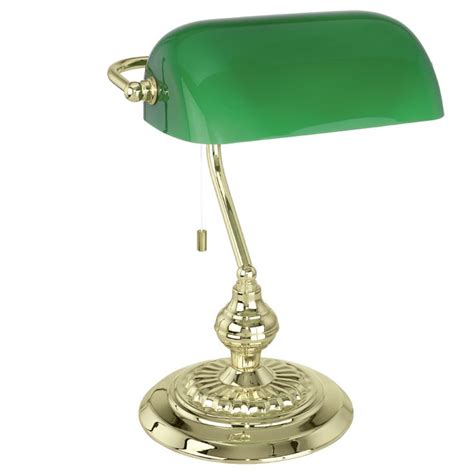 a green glass desk lamp sitting on top of a gold plated stand with a white background