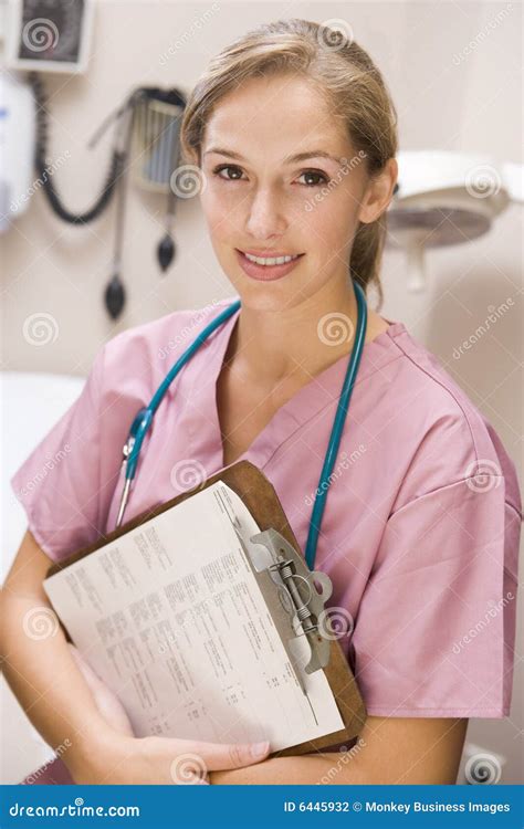 Young Female Doctor in Scrubs,Holding a Clipboard Stock Photo - Image ...