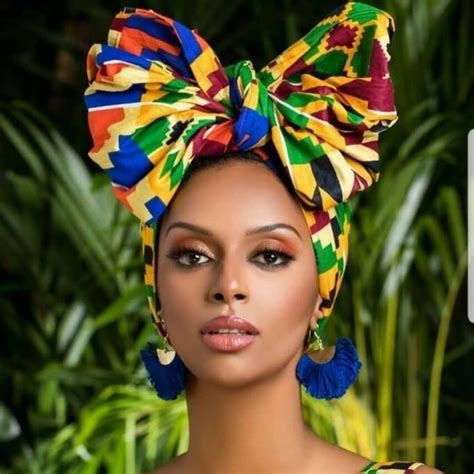 a woman wearing a colorful head wrap and earrings