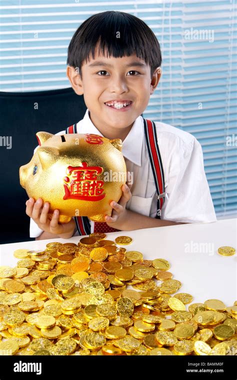 Young Boy With Gold Coins Smiling Happily Stock Photo - Alamy