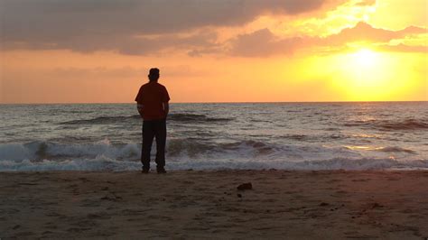 The man staring at the ocean