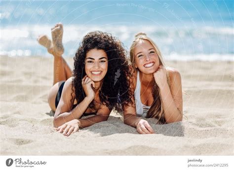 Two women on the sand of a tropical beach - a Royalty Free Stock Photo ...